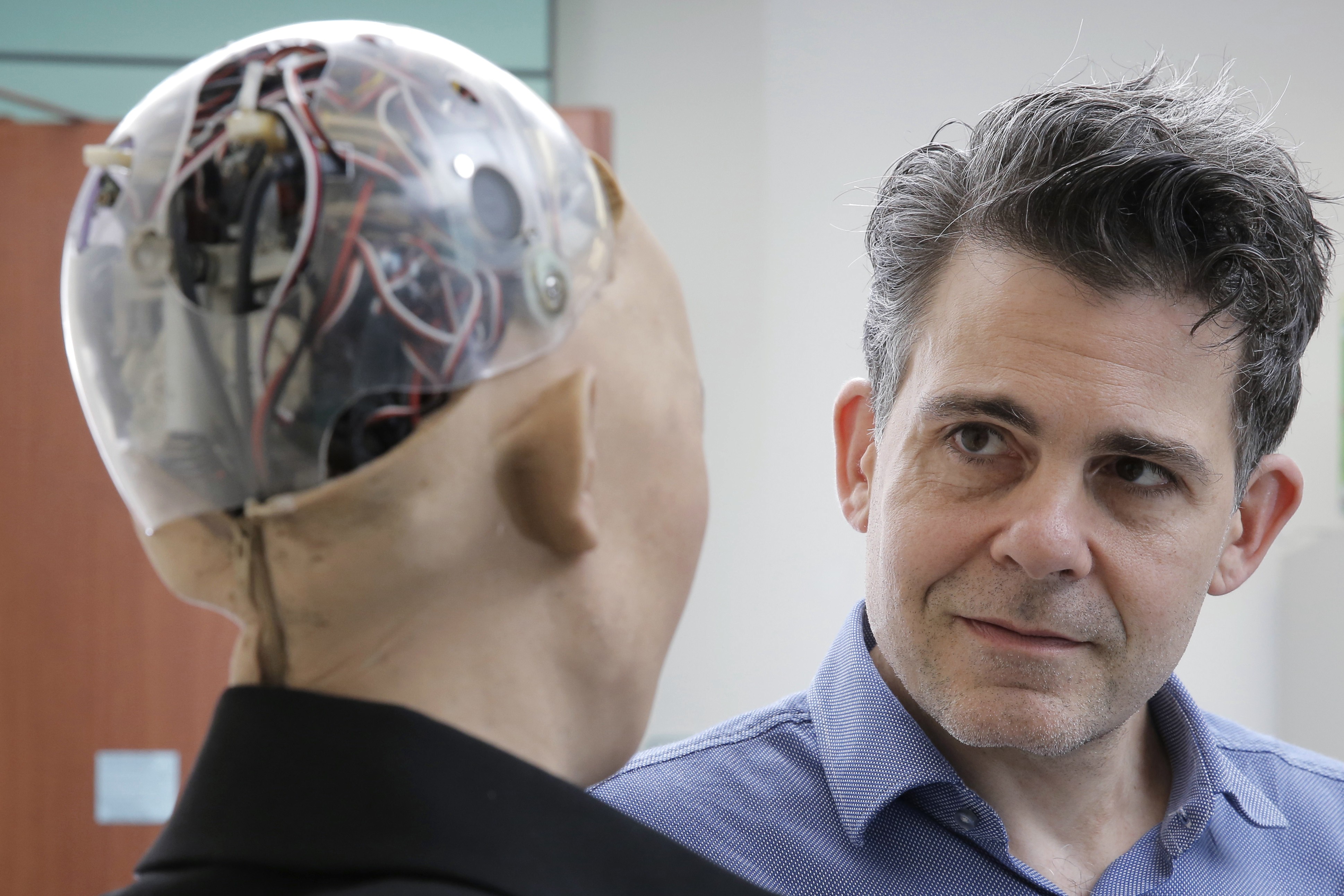 David Hanson, the founder of Hanson Robotics, talks with his company's flagship robot Sophia powered by artificial intelligence in Hong Kong. Hanson envisions a future in which AI-powered robots evolve to become “super-intelligent genius machines” that can help solve mankind’s most challenging problems. Photo: AP