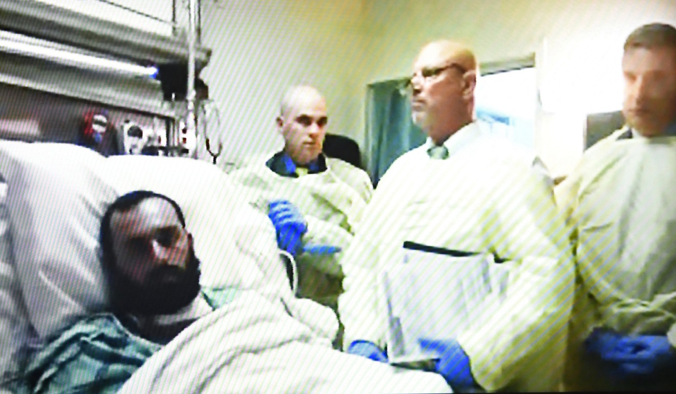 Ahmad Khan Rahimi, left, appears via video from his hospital bed in Newark, New Jersey, during a court hearing at the Union County Courthouse, on October 13, 2016. Photo: The Record via AP