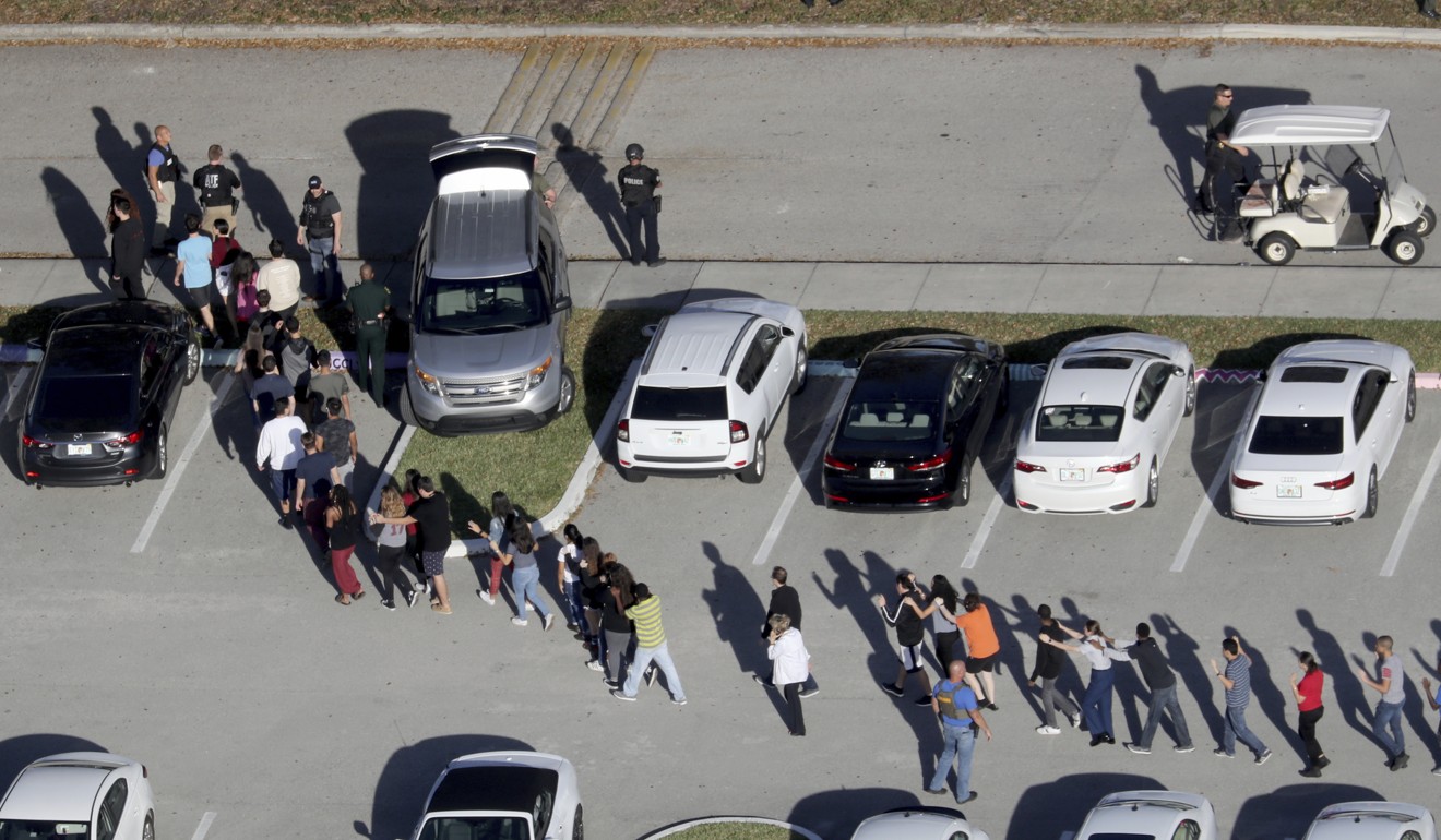 Students are evacuated by police from Marjorie Stoneman Douglas High School. Photo: AP