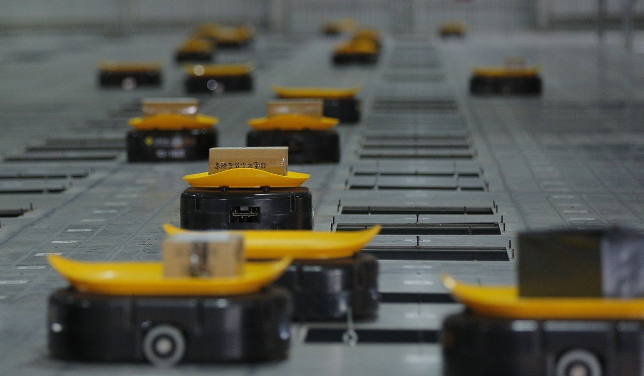 Automated sorting robots carry packages at the parcel processing centre of STO Express in Tianjin, a northern coastal city in China. STO Express was the first successful express delivery service company established in rural Tonglu county in the eastern coastal province of Zhejiang. Photo: EPA