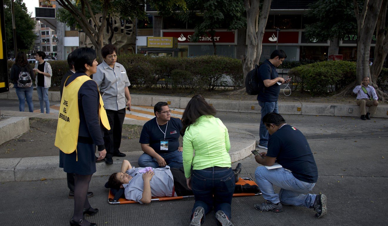 A woman is helped outside after a 7.2-magnitude earthquake shook Mexico City on Friday afternoon. Photo: AP