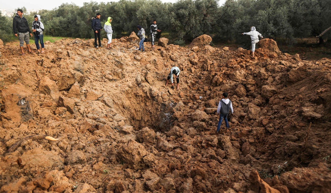 Palestinians check the site of an Israeli air strike in Gaza City. Photo: AFP