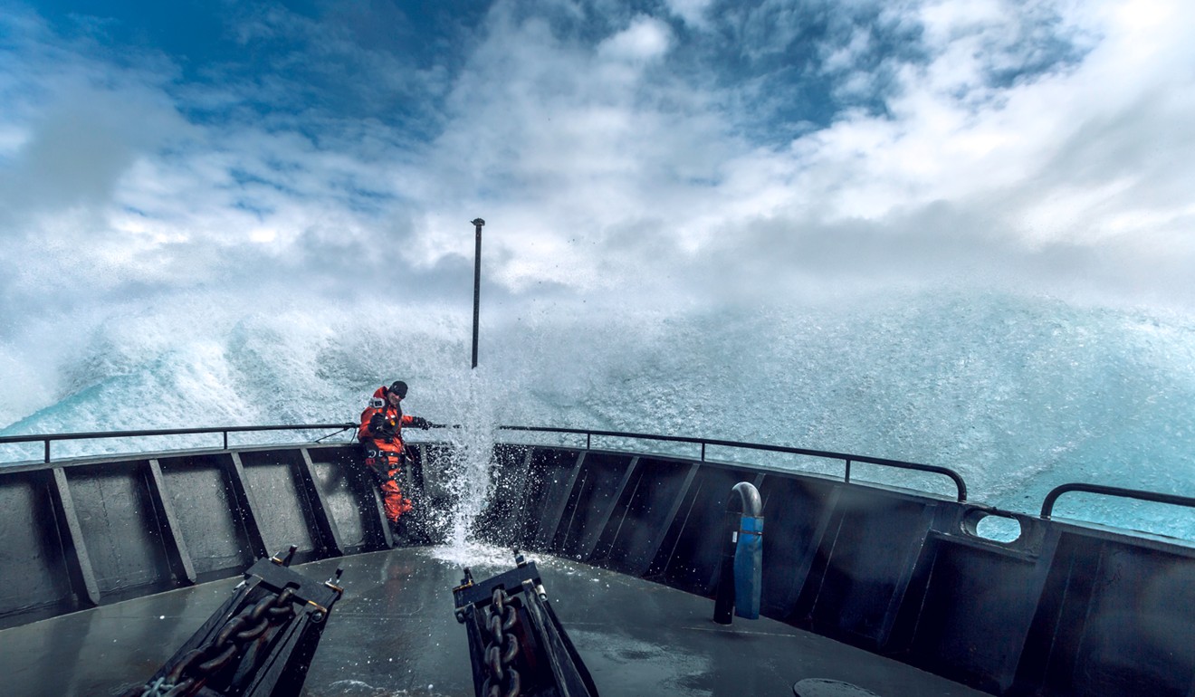 A crew member on the bow of the Bob Barker endures dangerous conditions at sea. Picture: Simon Ager/Sea Shepherd