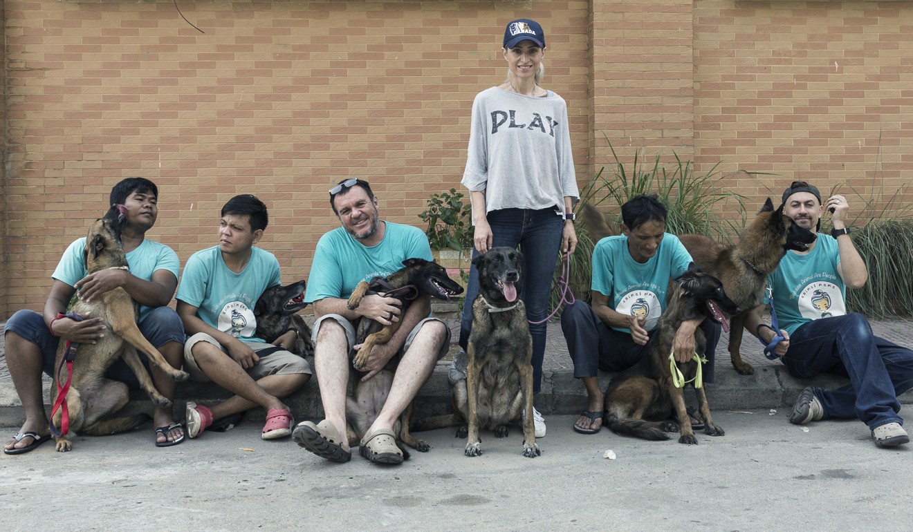 Taking a rest after one of their daily walks: Khouri and staff from Animal Mama (from left) Sothea Sun with Bela, Theara Run with Kaste, Darren Harris with Beatrix, Khouri with Muriel, Sarath Sam with Bonny, and Lee Fox-Smith with Diana. Photo: Enric Catala