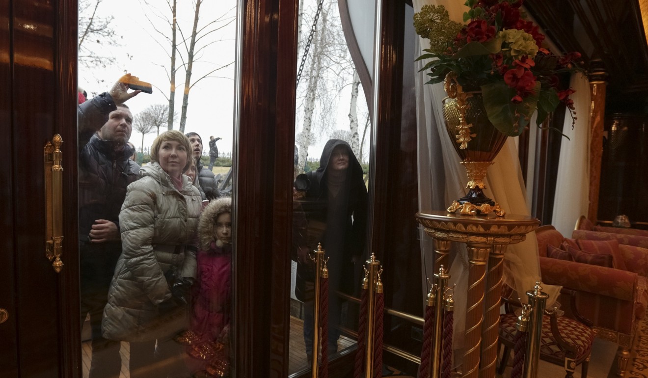 People look through windows of the vast, lavish Mezhyhirya residence of Ukraine's former president Viktor Yanukovich. Photo: Reuters