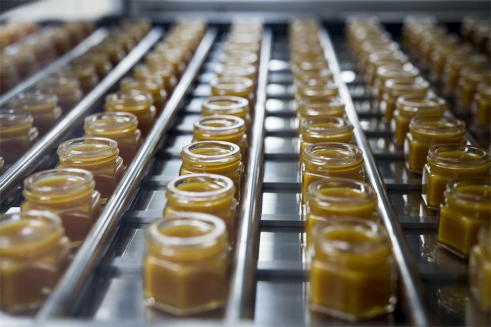 Tiger Balm jars being filled at the Haw Par Corporation's Tiger Balm factory. Photo: Christopher DeWolf