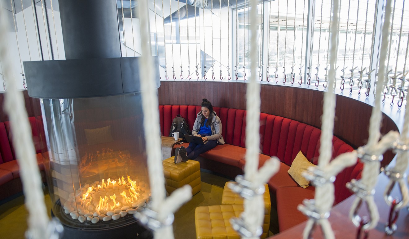An employee works near a fireplace at the new Google facility. Photo: Bloomberg