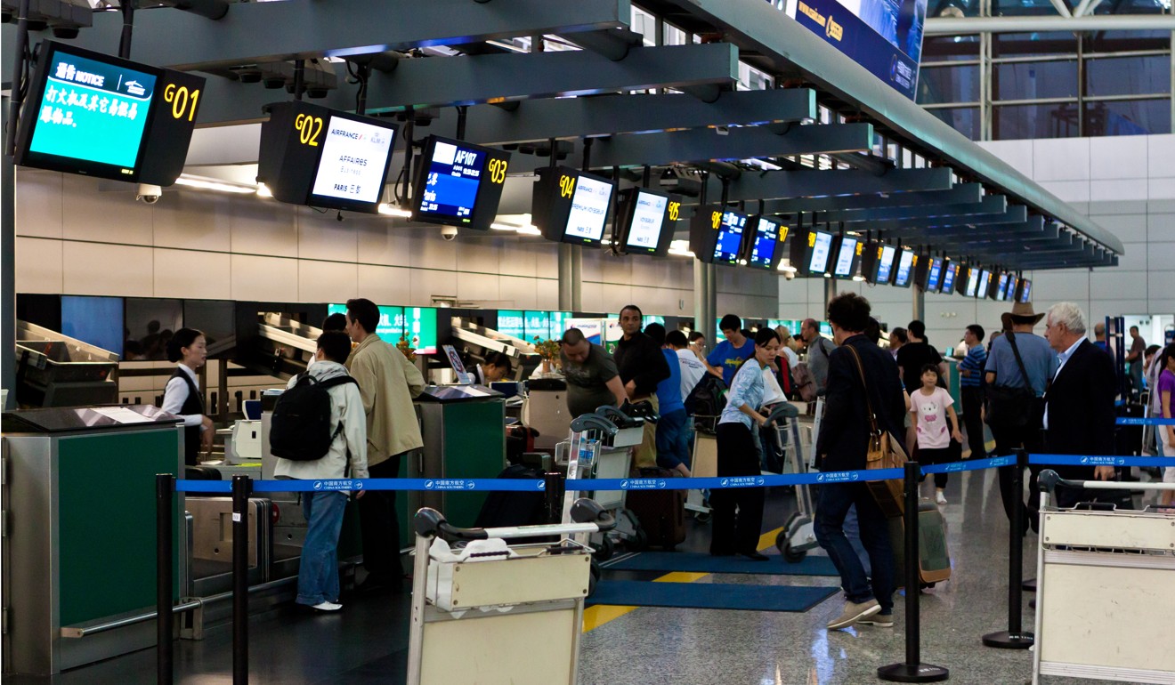 Passengers check in at Baiyun International Airport in Guangzhou. Photo: Imaginechina
