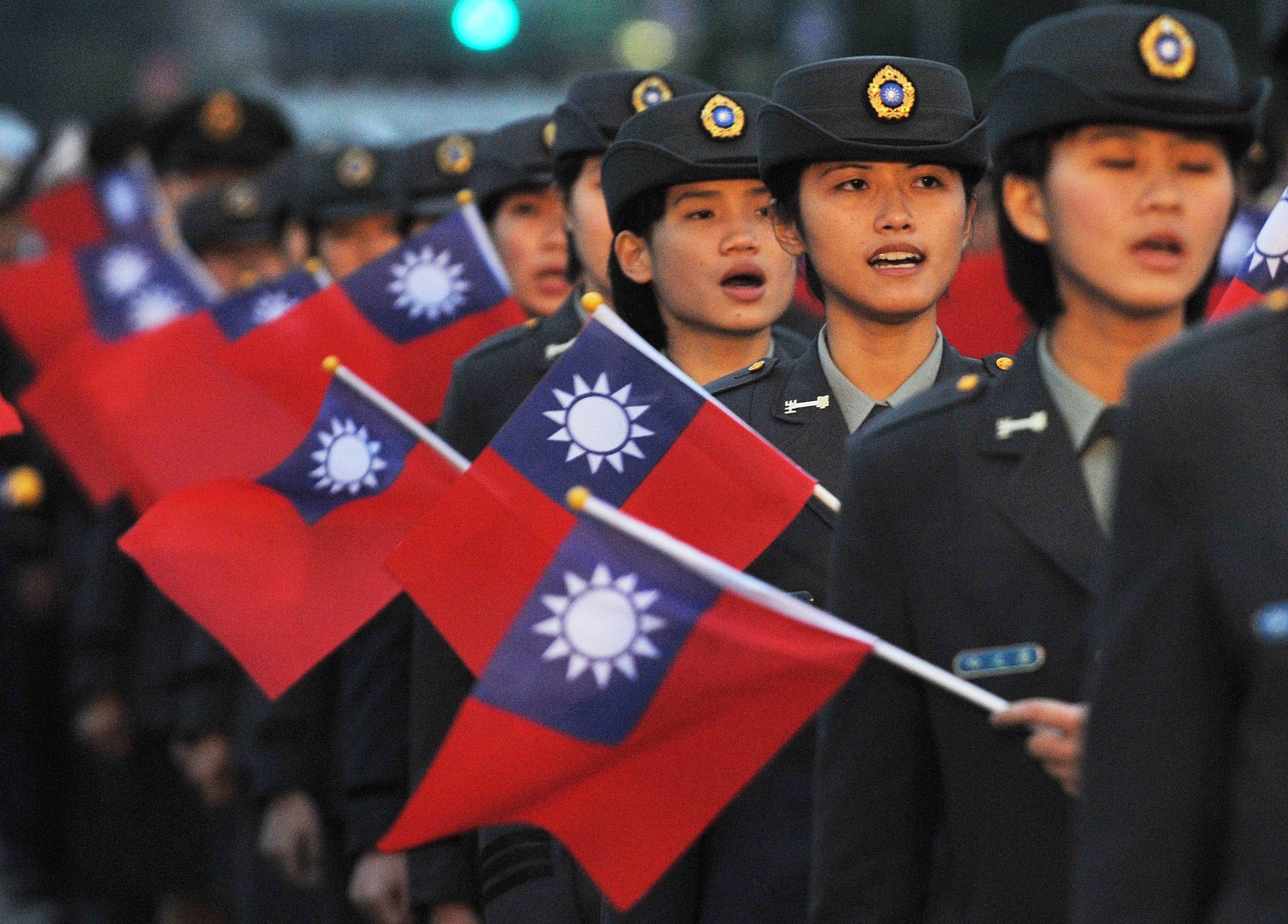 Military school students attend a flag-raising ceremony in Taipei. The self-ruled island is expected to come under greater unification pressure if Xi Jinping stays on as Chinese president past 2023. Photo: AFP