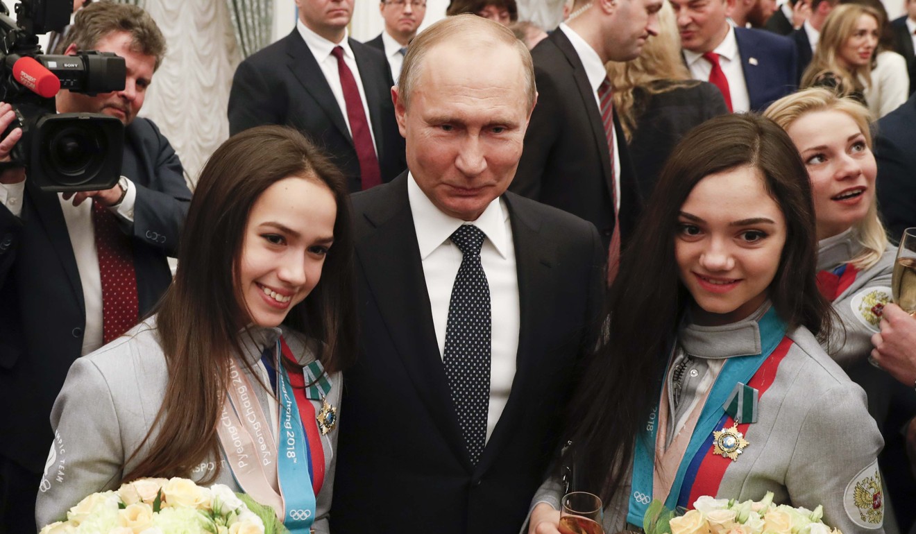 Russian President Vladimir Putin (centre) poses for a picture with Alina Zagitova (left) and Evgenia Medvedeva, skaters and prizewinners of the 2018 Pyeongchang Winter Olympic Games, at an awarding ceremony at the Kremlin in Moscow on Wednesday. Russia has denied government involvement in the doping scandal. Photo: Reuters