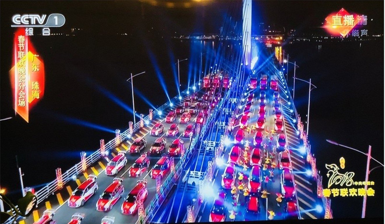 Performers dance around driverless cars lined up on the Hong Kong-Zhuhai-Macau bridge for the Spring Festival Gala segment