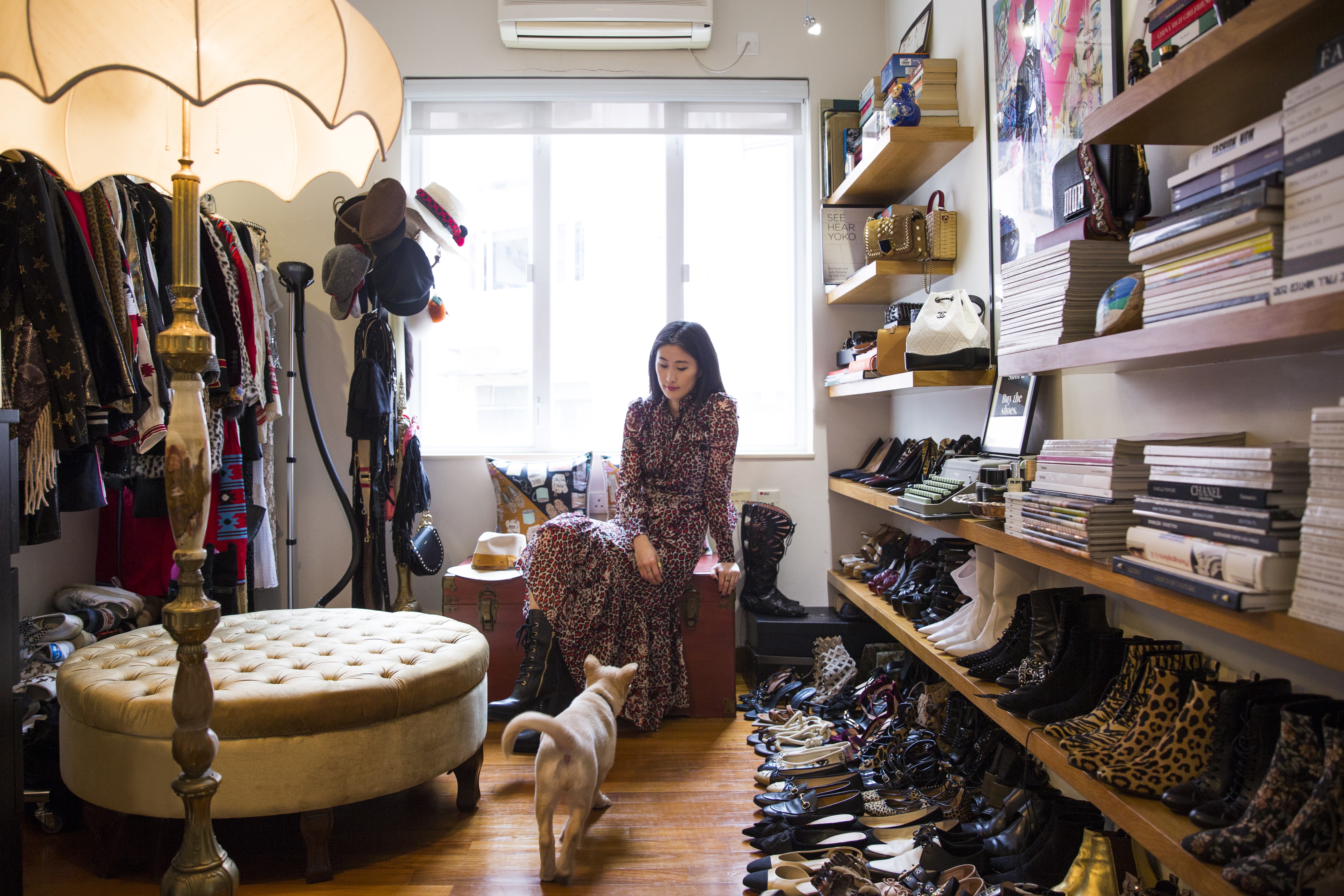 Justine Lee at home wearing a dress by Saint Laurent and boots by Tod’s. Photo: Michelle Wong