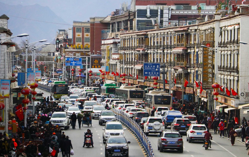 Vehicles drive along a busy street in Lhasa, capital of western China’s Tibet autonomous region. Protests in the city 10 years ago ended in a violent crackdown and the deaths of 13 people. Photo: Xinhua