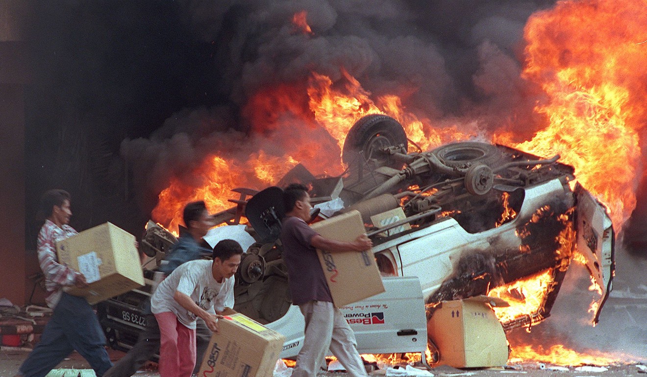 Indonesian mobs burn cars and Chinese shops in the days following the fall of dictator Suharto. Photo: AFP