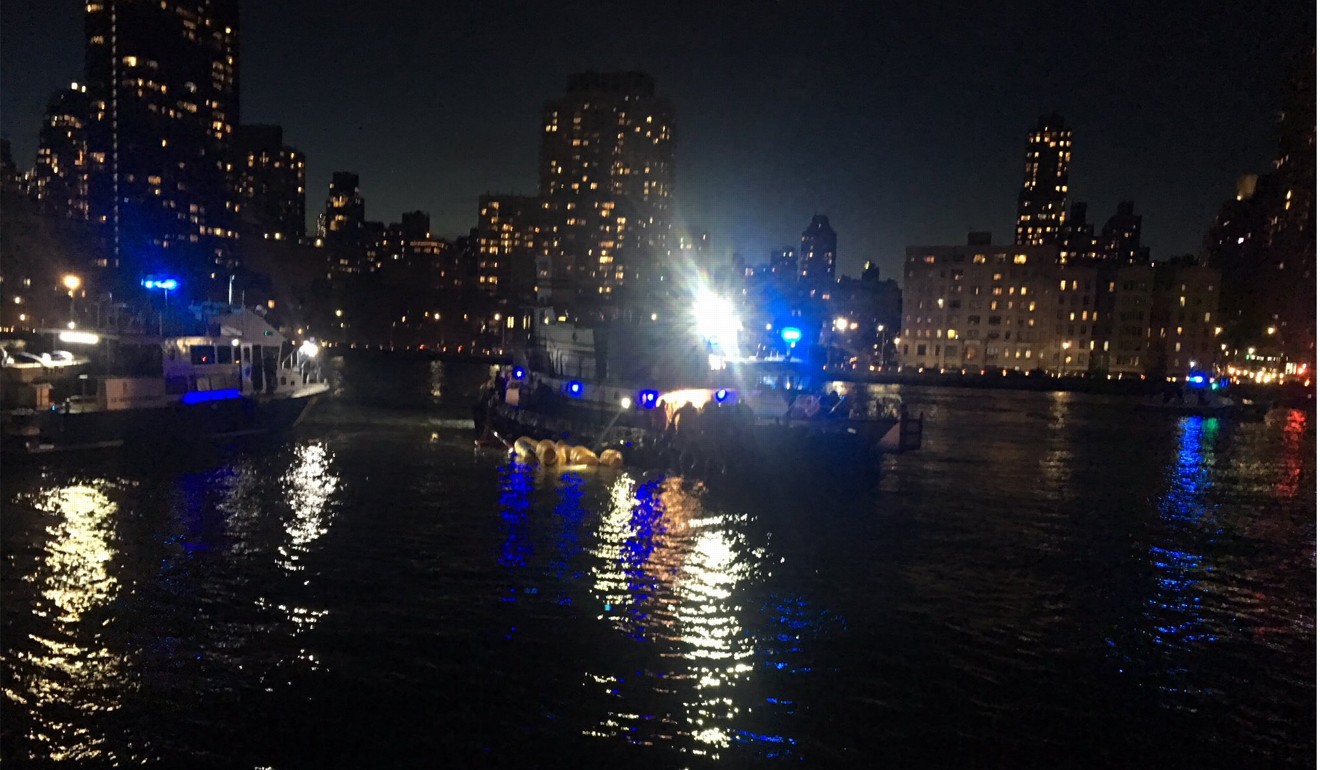 A handout photo made available by New York Fire Department shows emergency responders on scene after a helicopter crashed in the East Rive. Photo: EPA