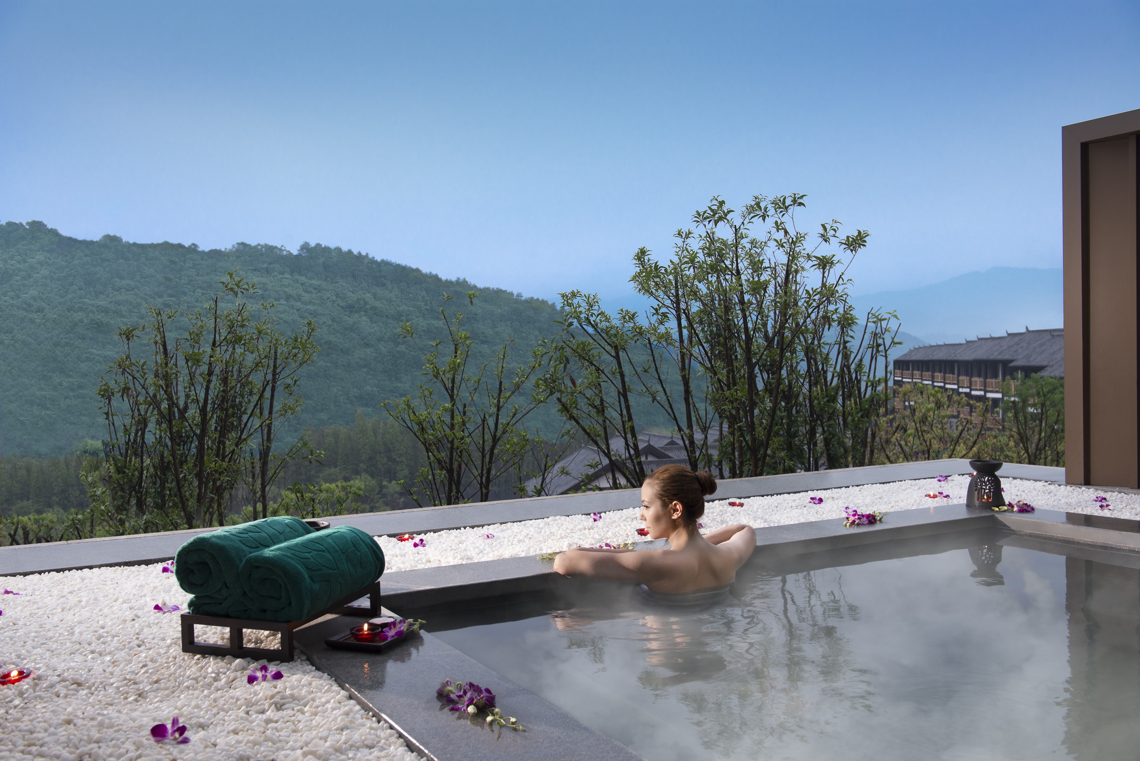 A guest relaxes in a private hot springs pool at Banyan Tree Chongqing Beibei, located in the hills near Chongqing city about a 50-minute car ride from the city’s airport.