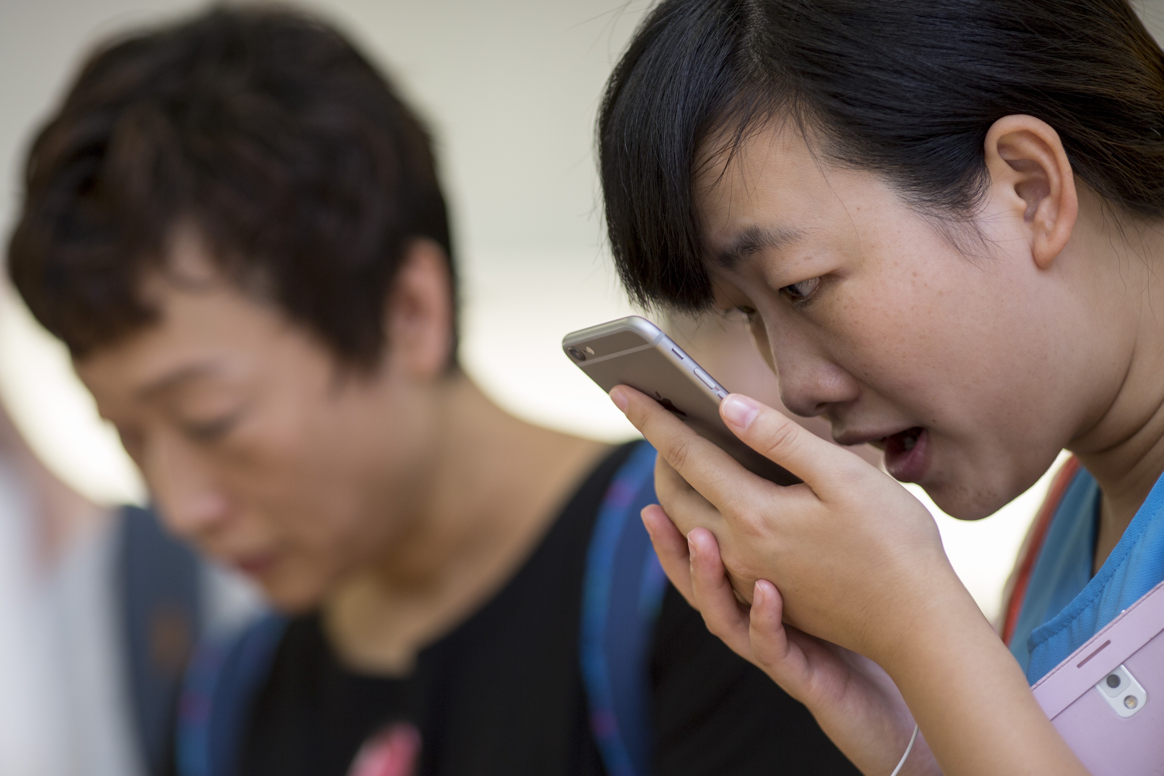 A customer tries the voice recognition function on an Apple iPhone in Causeway Bay. As technology advances, the features that offer consumers’ convenience may also make them vulnerable. Photo: Bloomberg