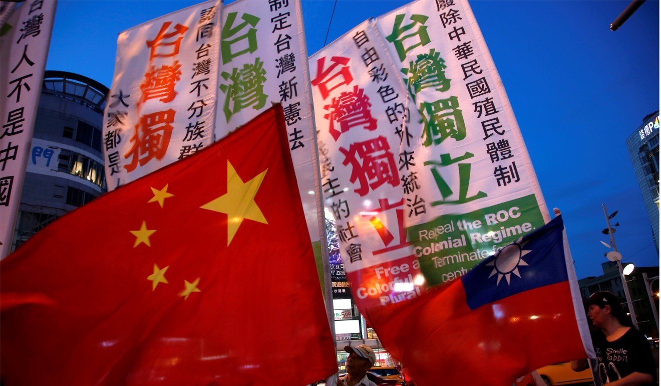 Members of a Taiwanese independence group march with flags around the group of pro-China supporters holding a rally calling peaceful reunification, in Taipei. The People’s Republic of China regards Taiwan as a breakaway province. Photo: Reuters