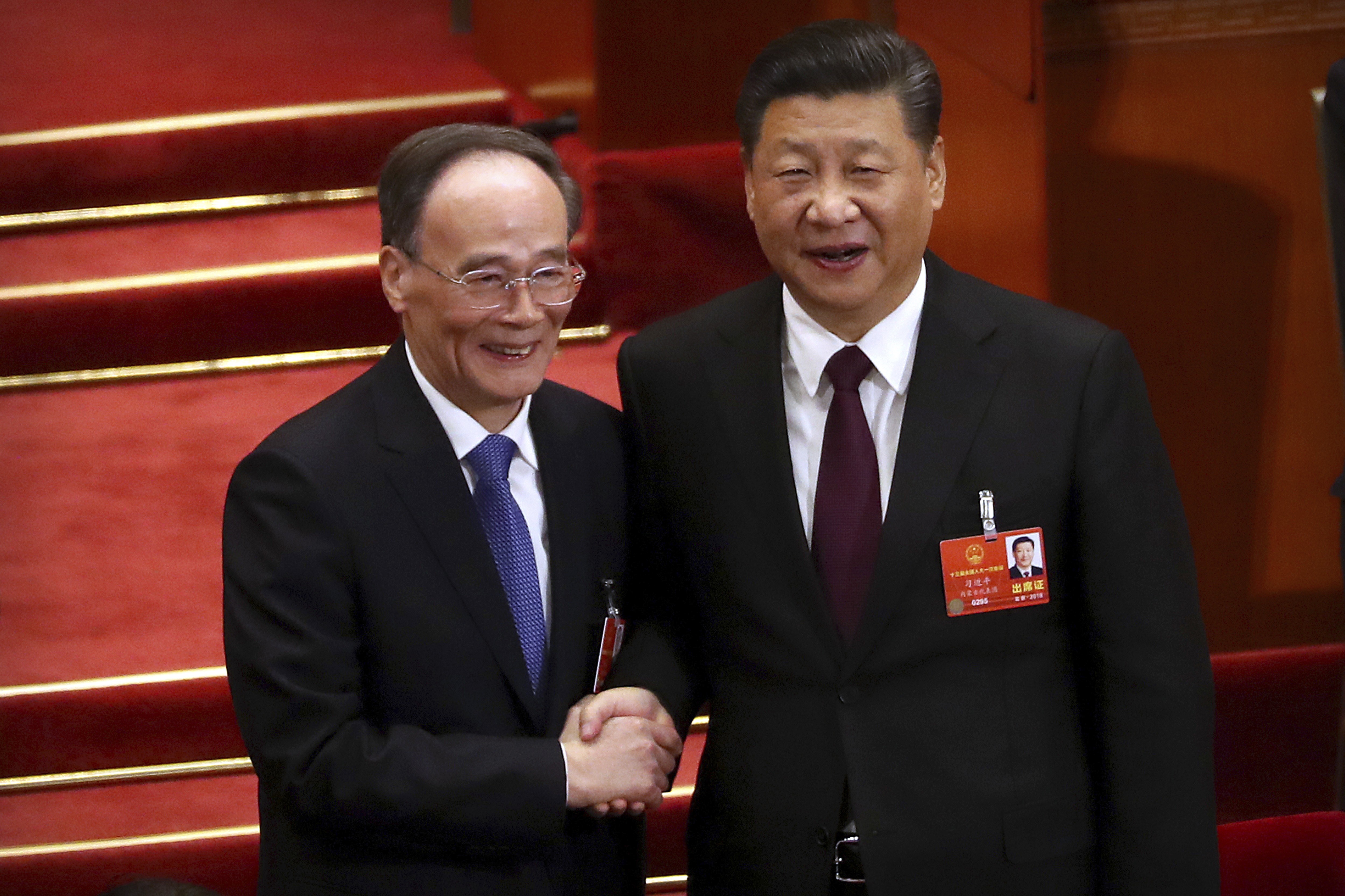 Xi Jinping (right) shakes hands with Wang Qishan after Wang was elected vice-president in Beijing on Saturday. Photo: AP