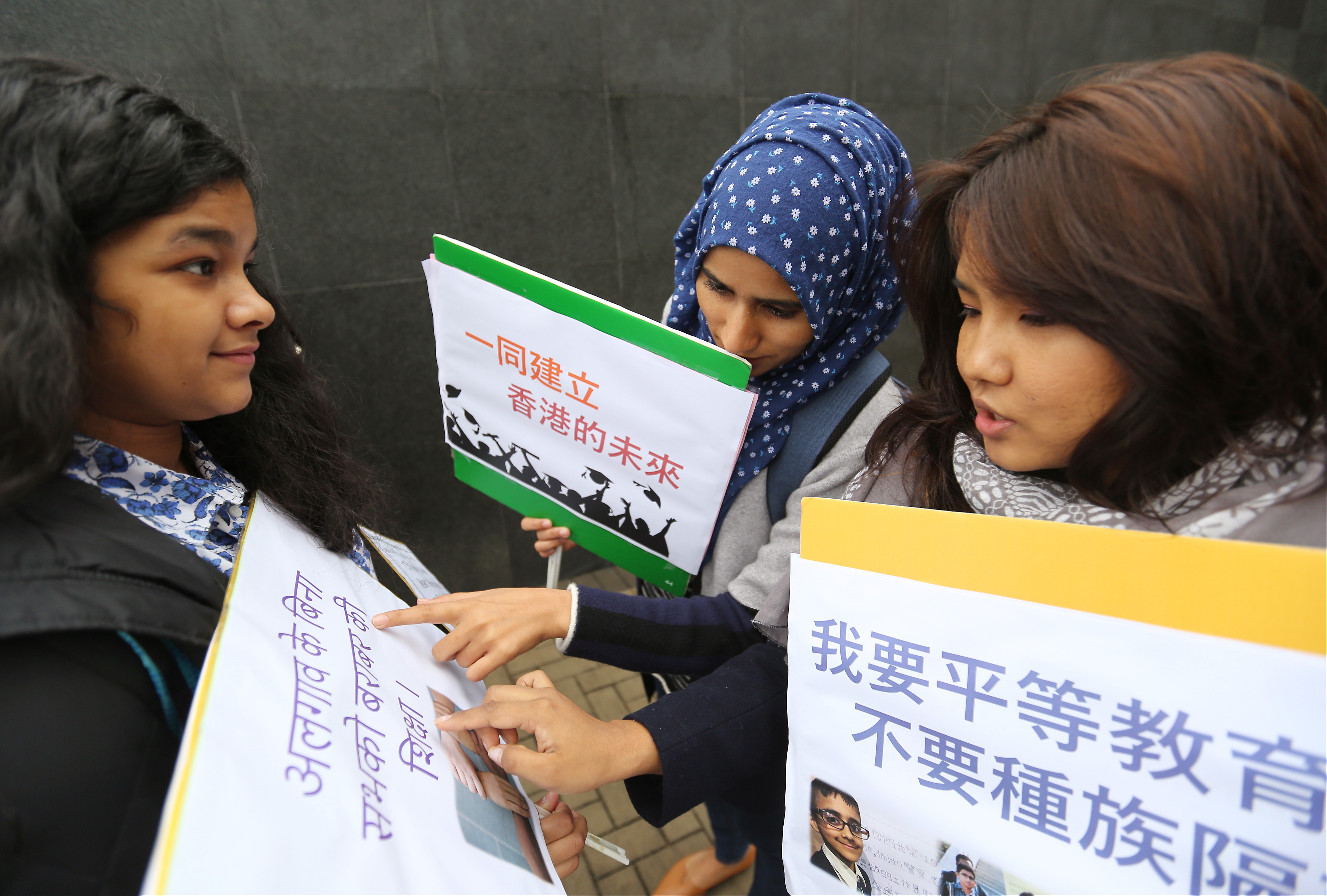 Young women from Hong Kong’s ethnic minority communities check their placards before submitting their wish list for the policy address to then chief executive Leung Chun-ying in 2017. Photo: Xiaomei Chen