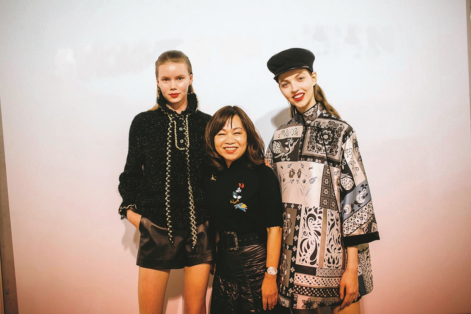 Madame Wang flanked by models at her autumn-winter 2018 show in Paris.