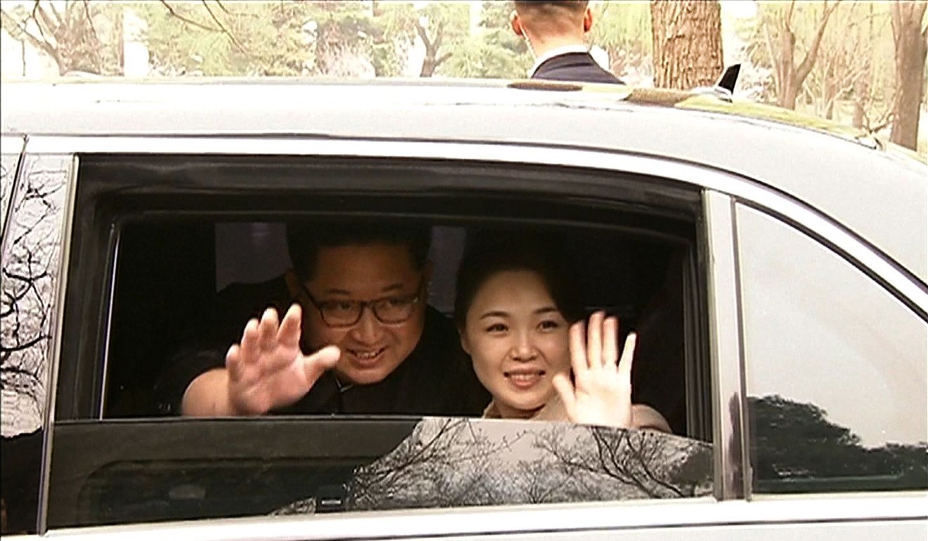 North Korea's leader Kim Jong-un and his wife Ri Sol-juu wave goodbye as they depart by car following a meeting with China's President Xi Jinping in Beijing this week. Photo: AFP