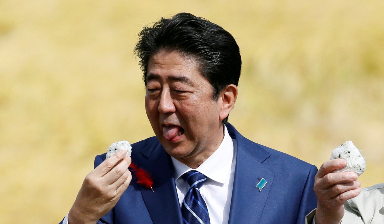 Japanese Prime Minister Shinzo Abe eats rice during an election campaign rally in Fukushima to prove the safety of the area’s produce. Photo: Reuters