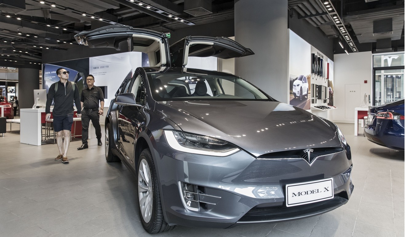 A customer looks at a Tesla Motors Inc. Model X electric vehicle on display at the company's showroom in Shanghai, China. File photo: Bloomberg