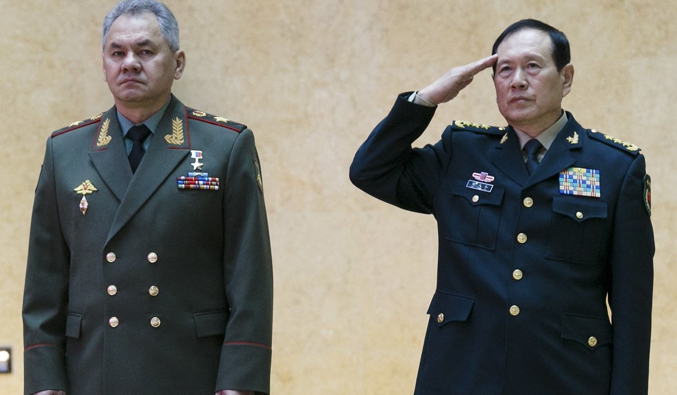 Chinese Defence Minister Wei Fenghe salutes as he and Russian Defence Minister Sergei Shoigu review an honour guard before their talks in Moscow on Wednesday. Photo: Russian Defence Ministry Press Service via EPA-EFE