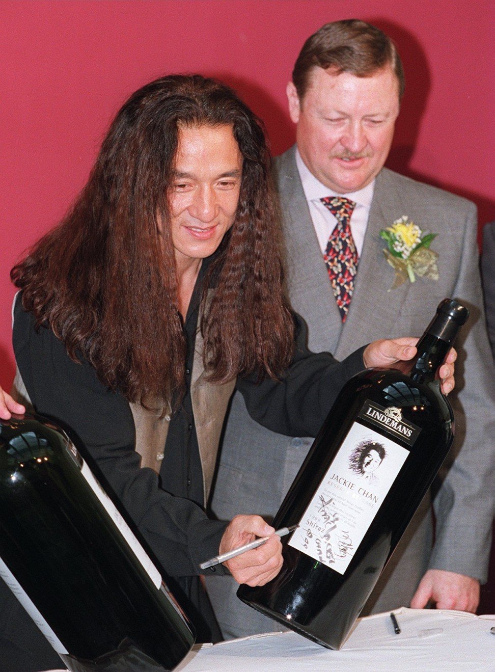 The actor with winemaker Philip John at the launch of Chan’s new wine, in 1999.