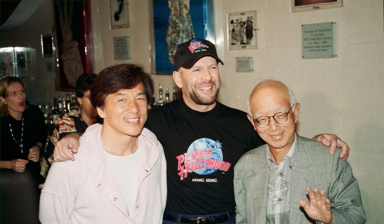Chan poses with American actor Bruce Willis and film distributor Raymond Chow Ting-hsing at Hong Kong's Planet Hollywood restaurant in 1995.