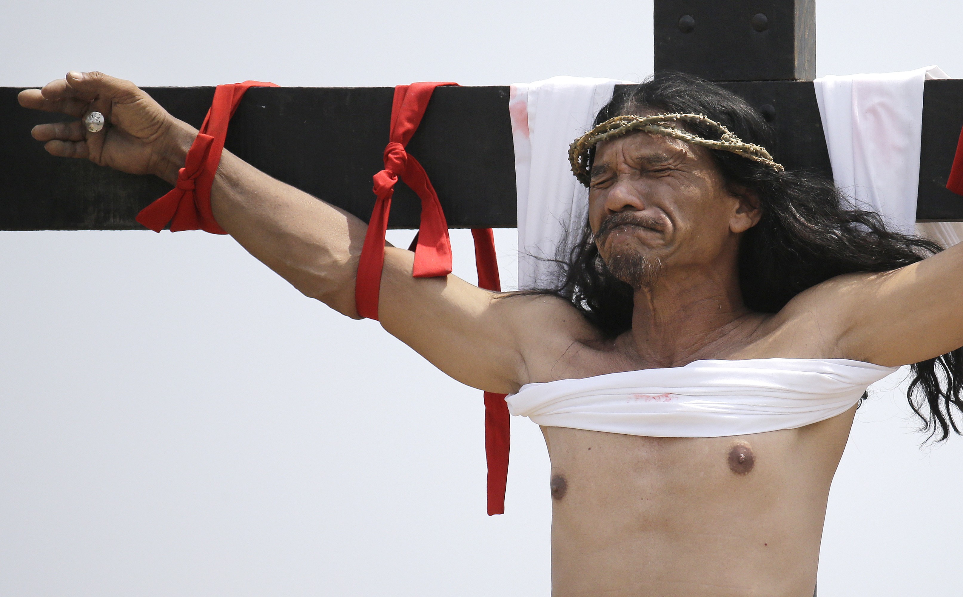 Ruben Enaje reacts after he was nailed to the cross for the 32nd year in a row during a re-enactment of Jesus Christ's sufferings as part of Good Friday rituals in the village of San Pedro Cutud, Pampanga province, northern Philippines. Photo: AFP