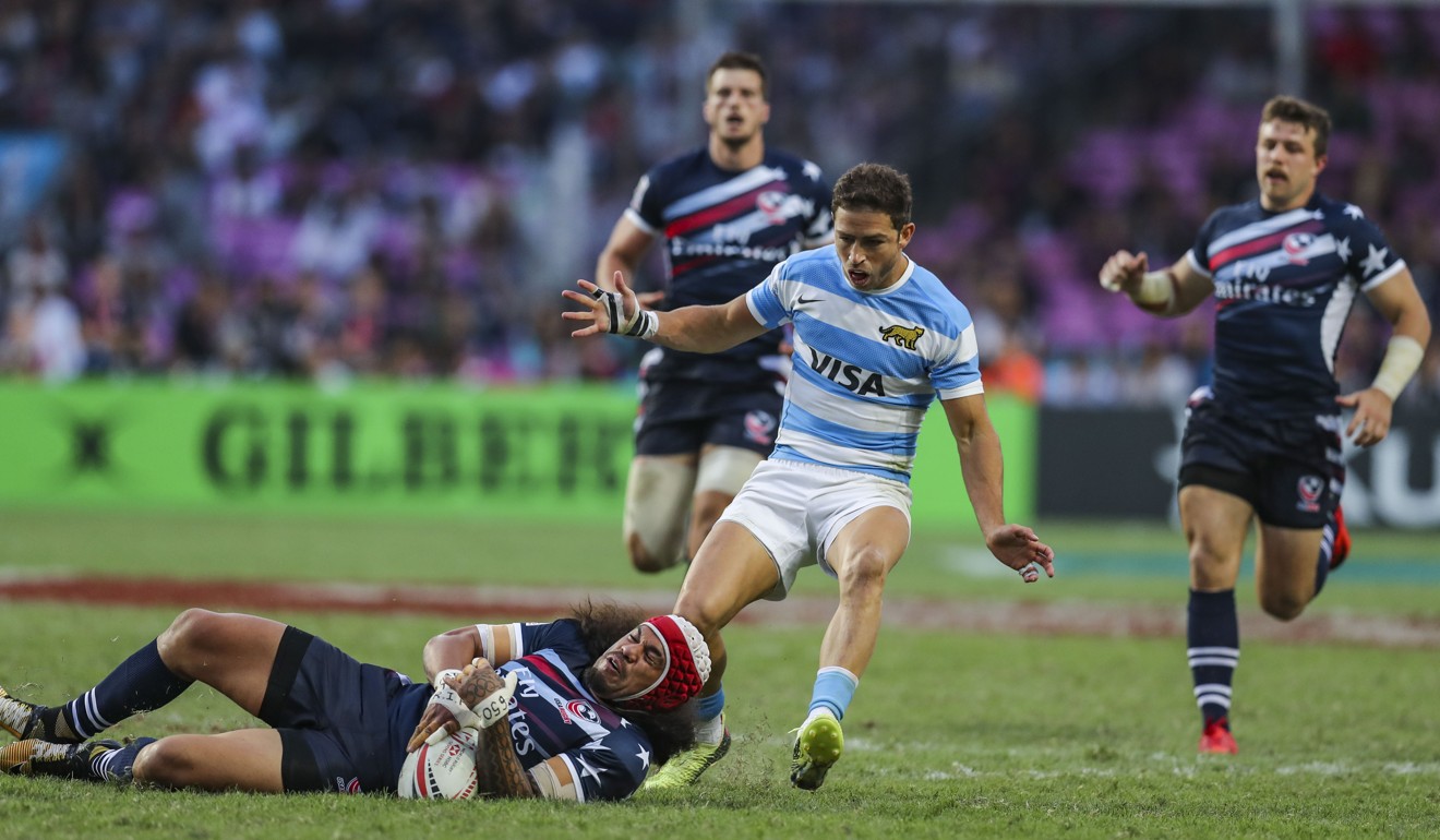 Argentina’s Franco Sabato (centre) goes to tackle a USA player during their Plate clash. Photo: Winson Wong