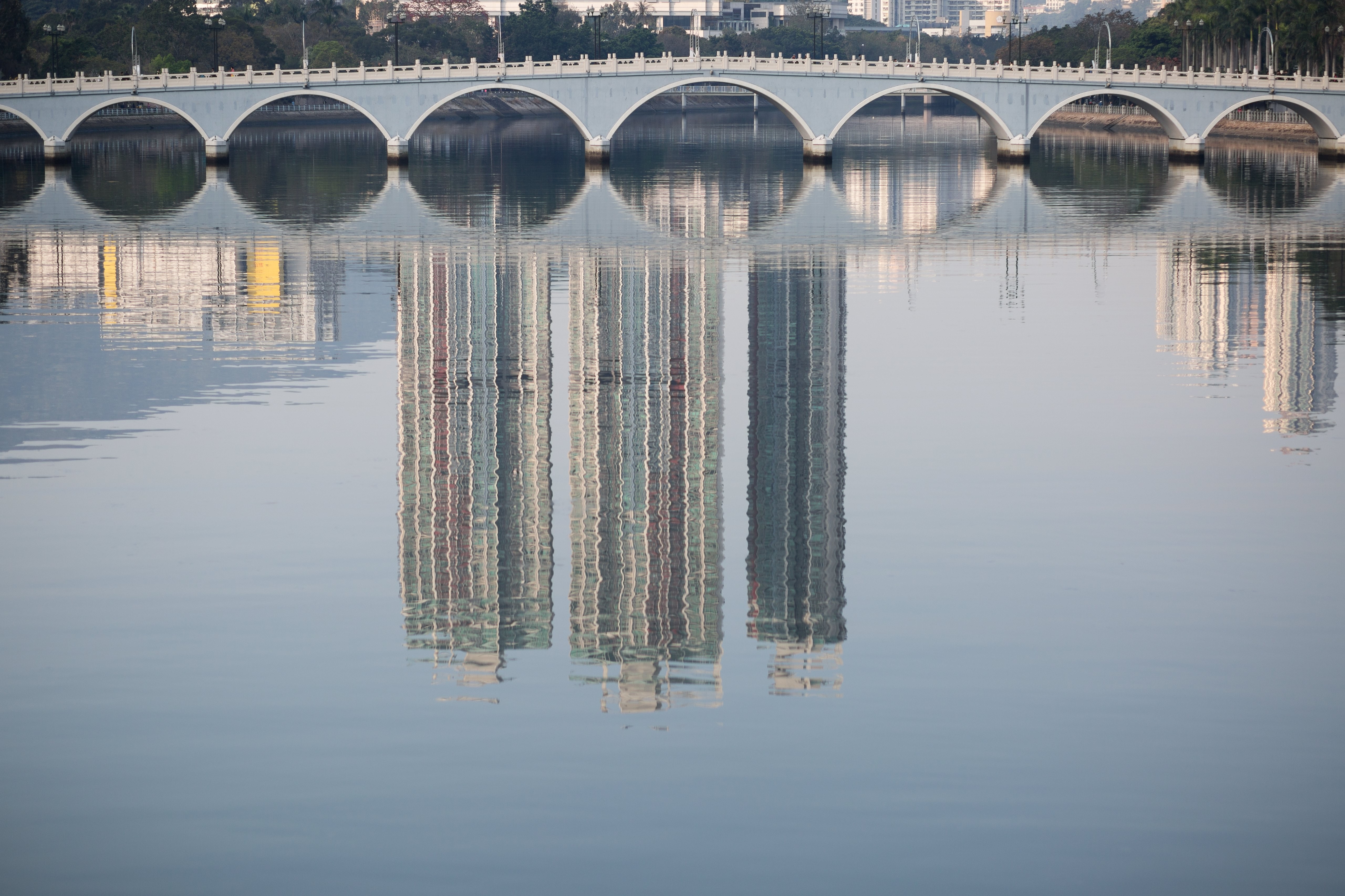 Residential buildings are reflected in the Shing Mun River in Shatin. Chinese developers are increasingly eyeing the secondary market in Hong Kong. Photo: EPA-EFE