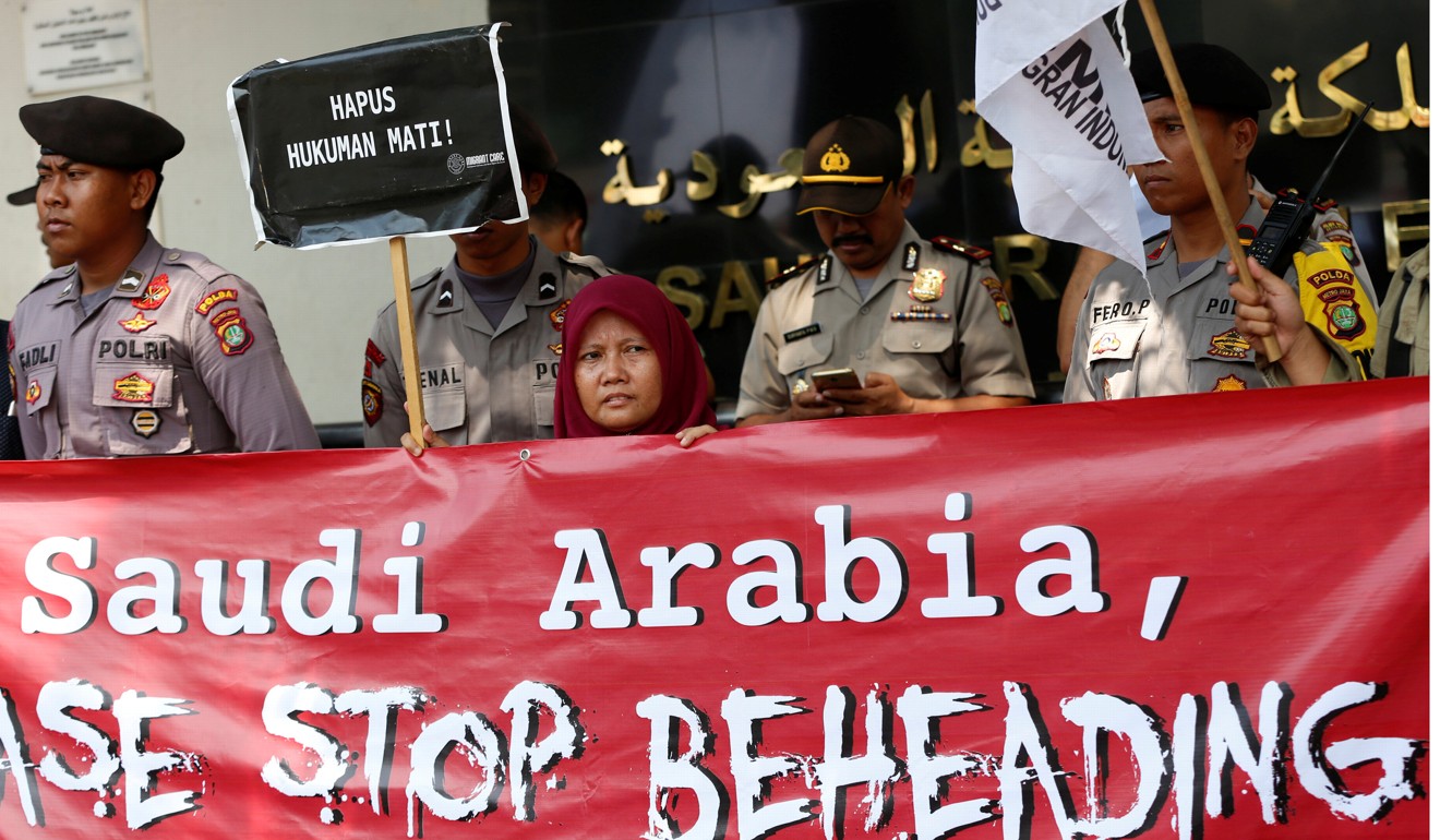 An activist holds a placard in front of the Saudi Arabia embassy during a protest over the recent execution of an Indonesian migrant worker for murder, in Jakarta. Photo: Reuters