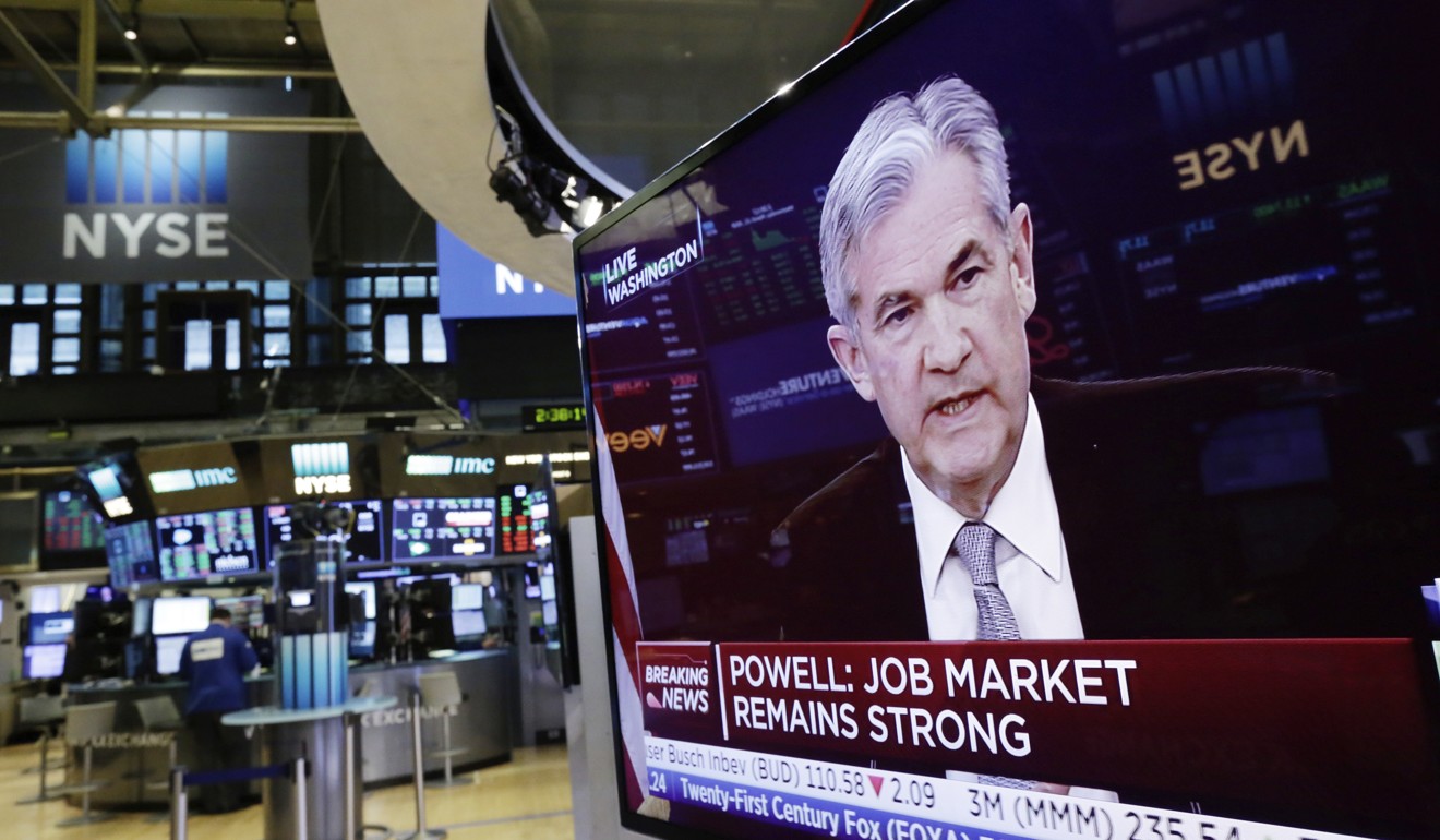 US Federal Reserve chairman Jerome Powell appears on a television screen on the floor of the New York Stock Exchange on March 21. The Fed has signalled that it will gradually raise its benchmark interest rate to reflect the stronger US economy. Photo: AP 