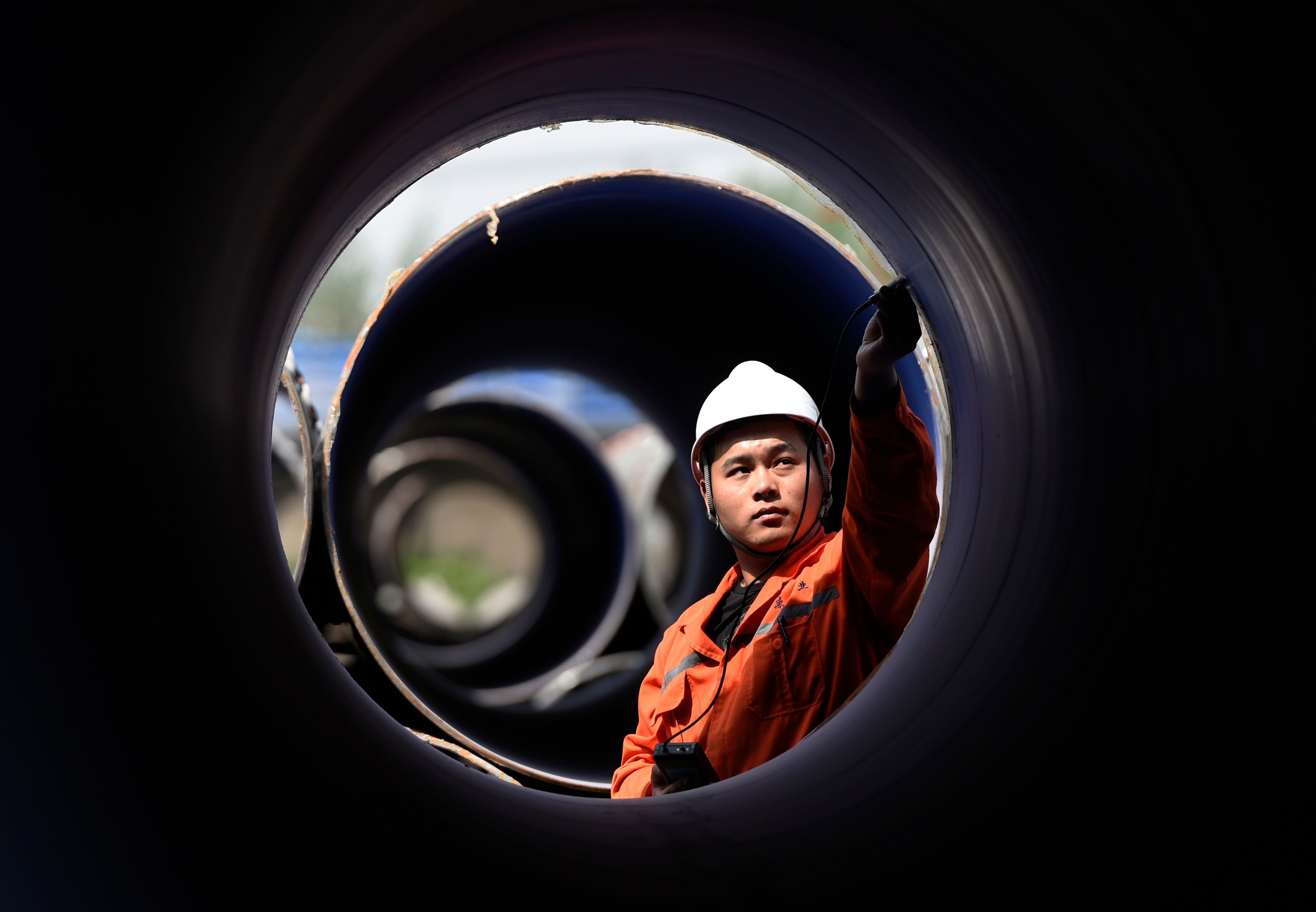A worker measures a steel pipe at a factory in Zouping, Shandong province, on April 18. US President Donald Trump has imposed tariffs of 25 per cent on steel imports and 10 per cent on aluminium imports. Photo: AFP 