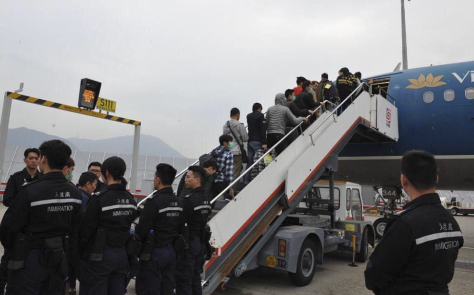 Asylum seekers and illegal immigrants being deported by Hong Kong immigration authorities. Photo: Handout