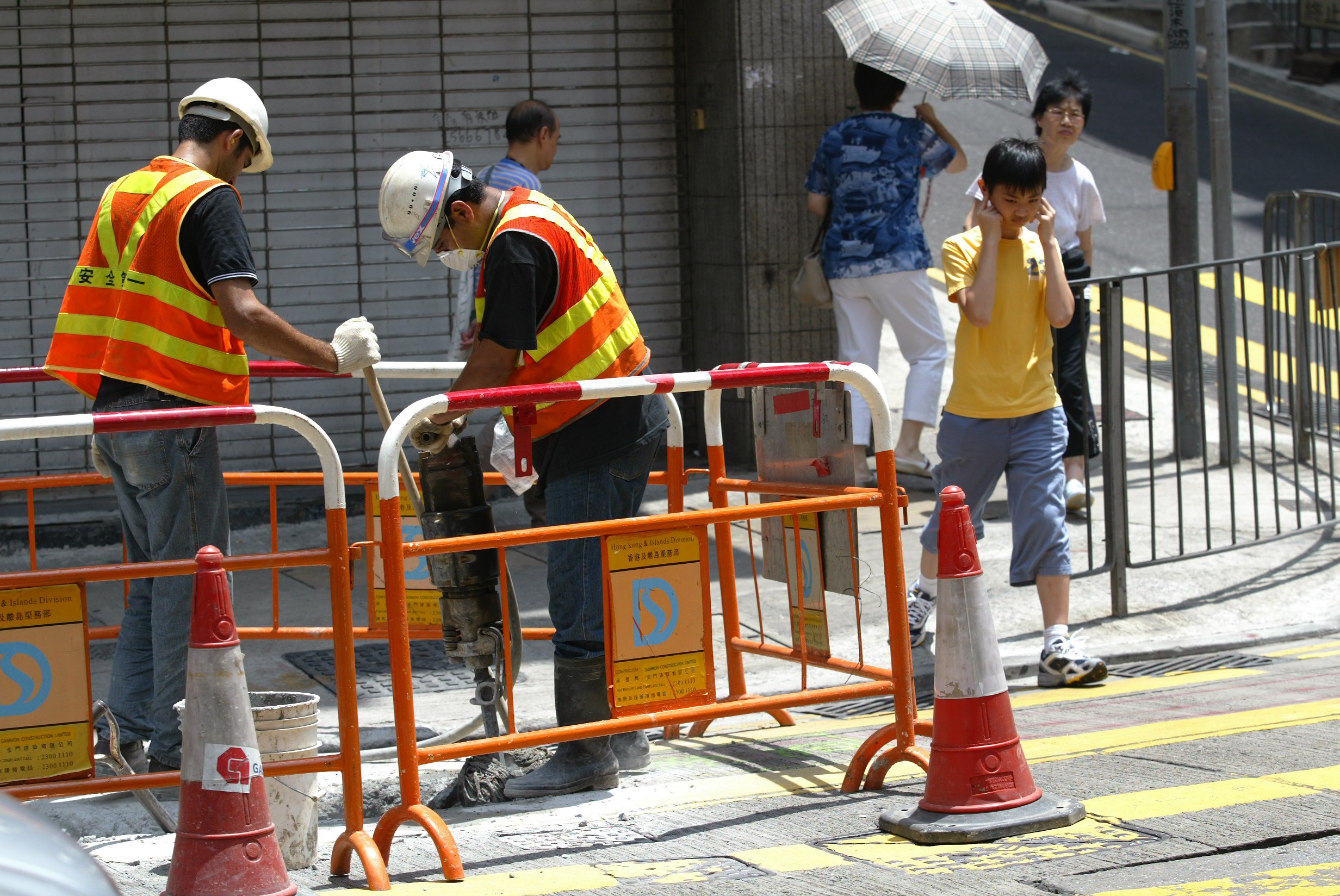 Construction workers with a jackhammer in Hong Kong.