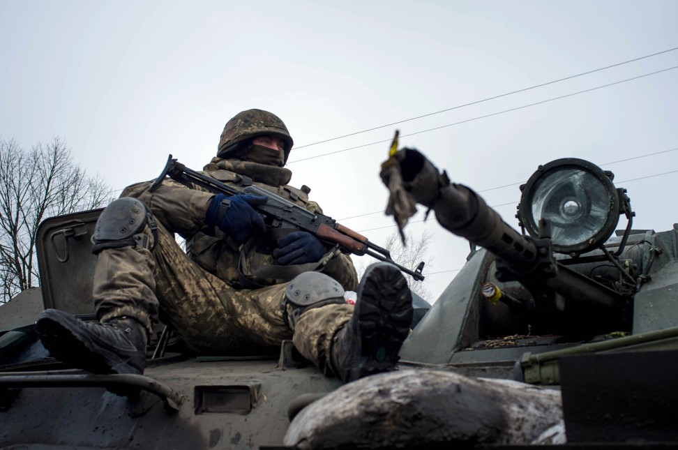 A Ukrainian serviceman rides on a tank during skirmishes with pro-Russian rebels in 2015. Photo: AFP