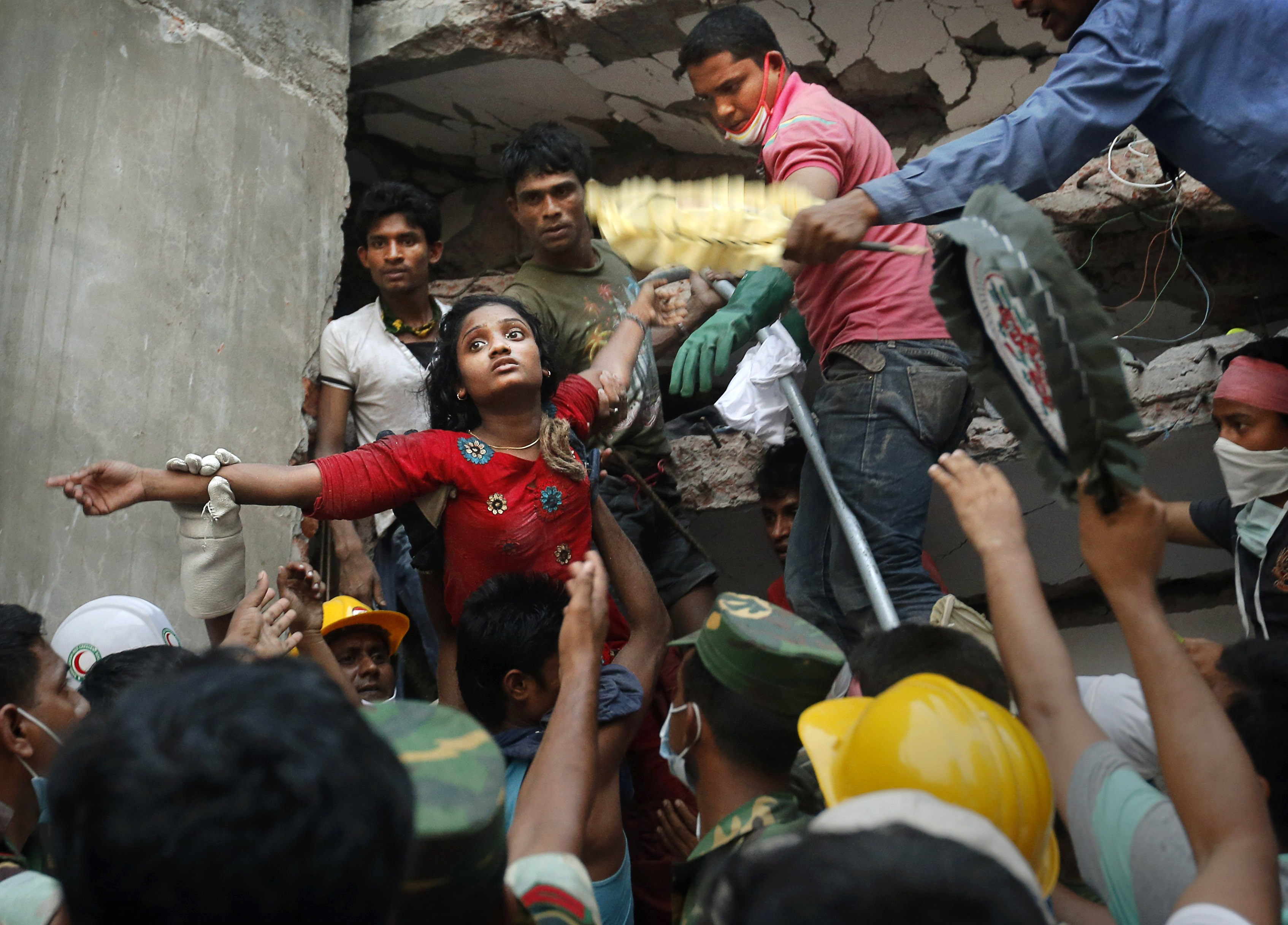 A Bangladeshi woman is lifted out of the rubble by rescuers at the site of the Rana Plaza building that collapsed in Savar, near Dhaka, Bangladesh, on April 25, 2013. Photo: AP