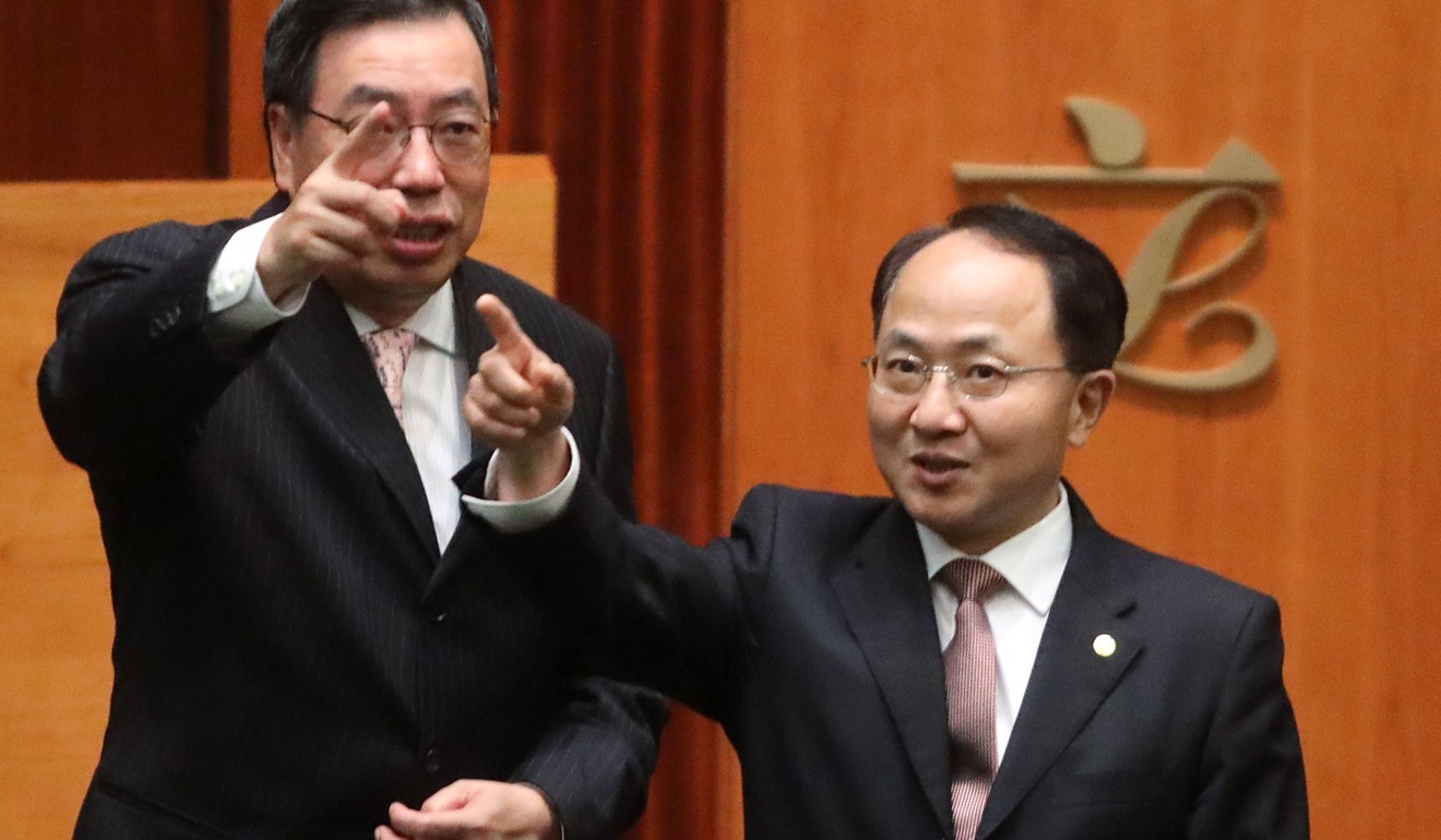Legco president Andrew Leung (left) shows Wang (right) around the chamber. Photo: Sam Tsang