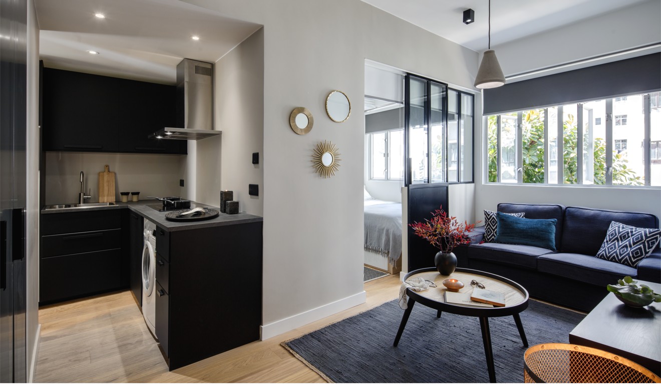Glass partitions allow natural light to flow throughout the apartment.