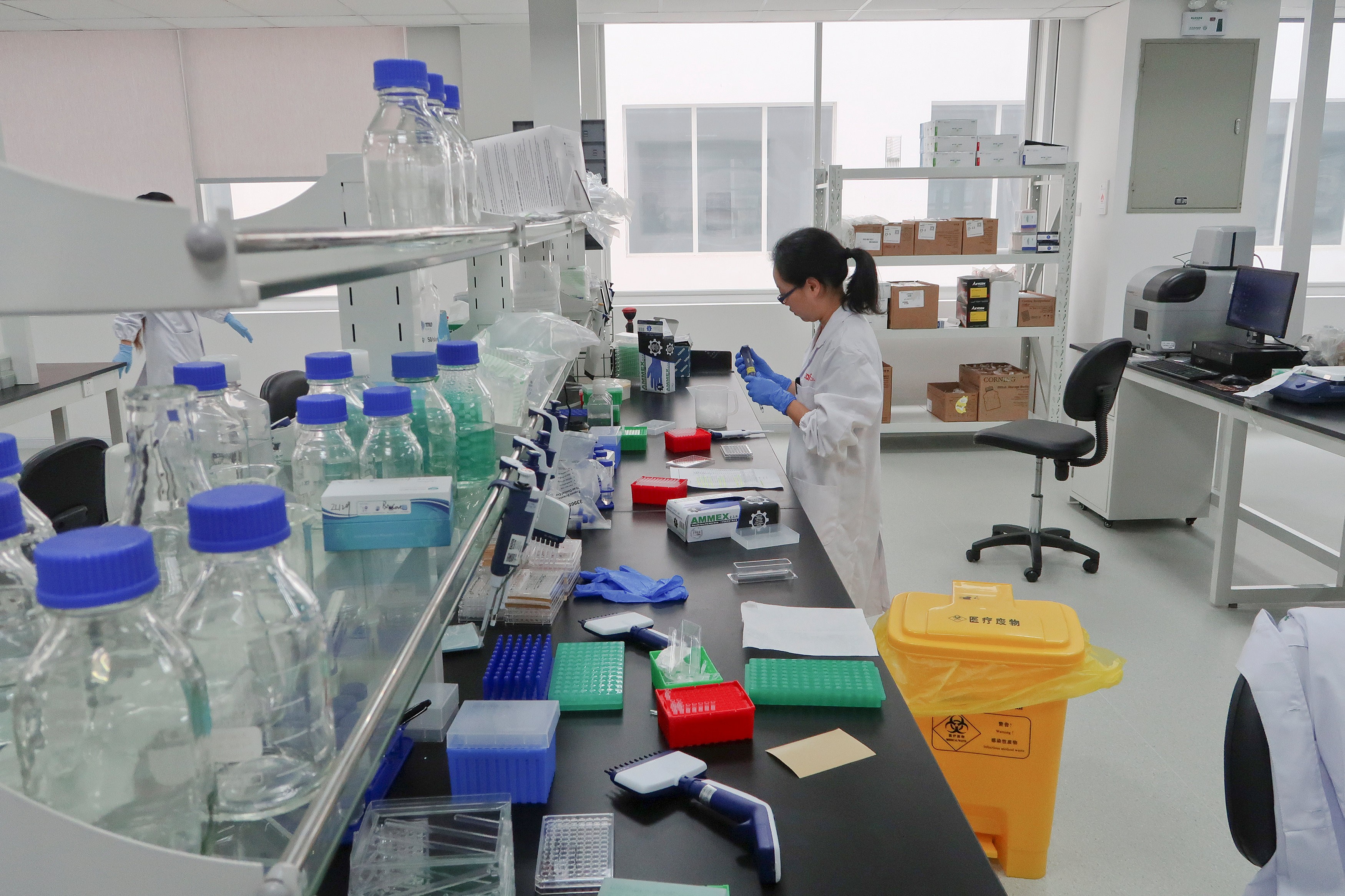 A scientist works at Zai Lab's drug development facility in Shanghai in October 2017. The Hong Kong stock exchange is amending its listing rules to attract biotech companies to list in the city. Photo: Reuters