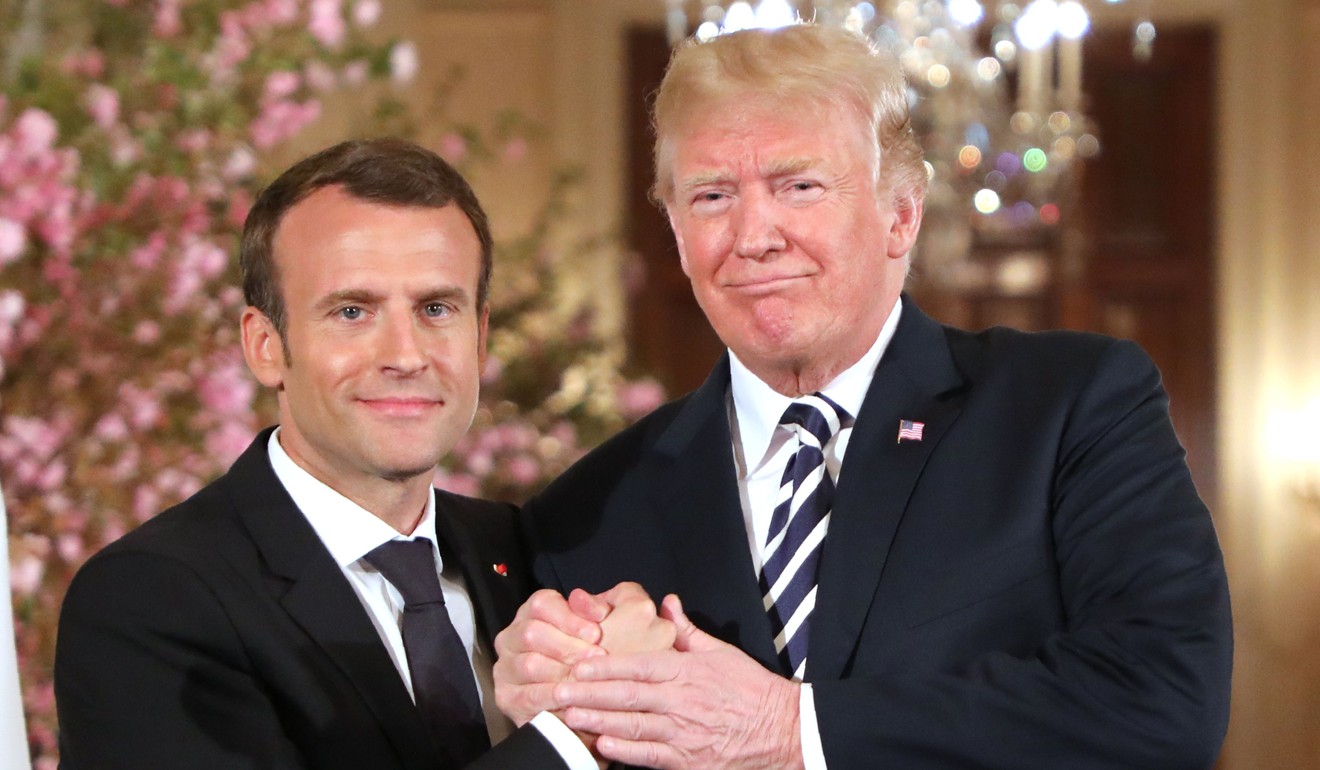 French President Emmanuel Macron and US President Donald Trump shake hands during a joint press conference at the White House in Washington on Tuesday. Photo: AFP 