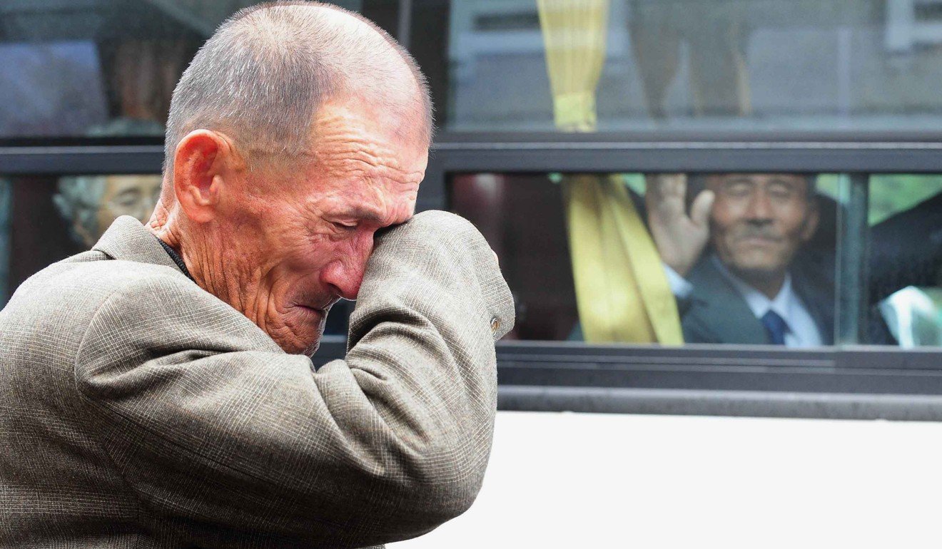 An elderly South Korean man weeps as a North Korean relative in the bus waves good-bye during a separated family reunion meeting. Photo: AFP