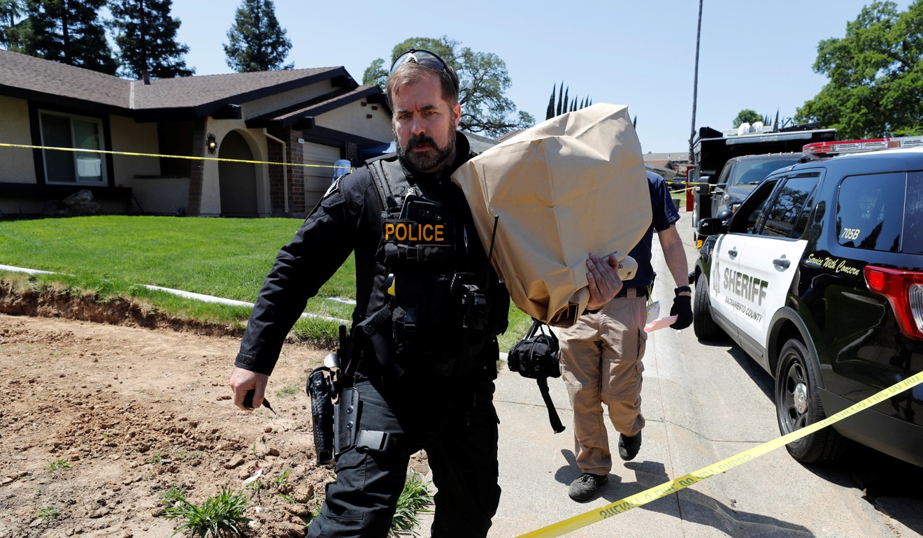 A police officer removing items in evidence bags from the home of Joseph James Deangelo on Thursday. Photo: Reuters