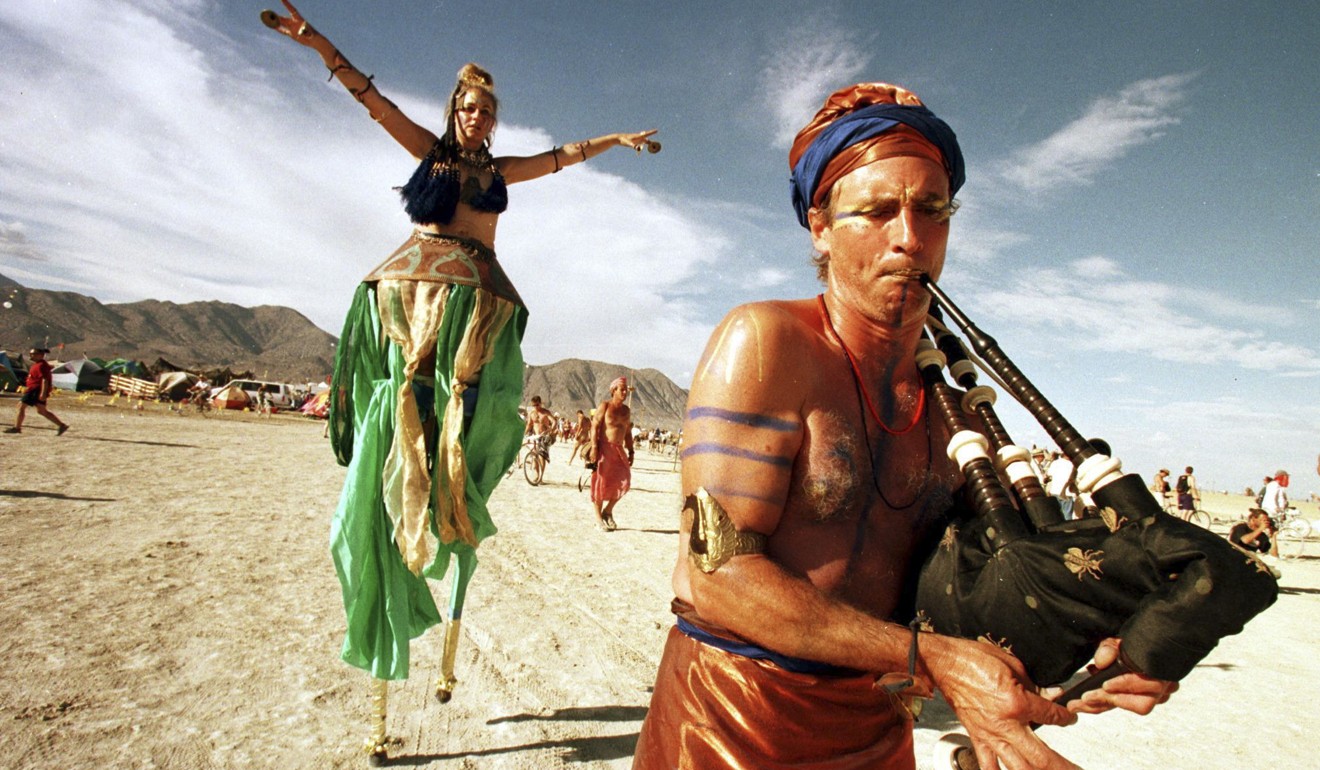 Performers cross a section of the desert in last year’s burning pan festival. Photo: AFP