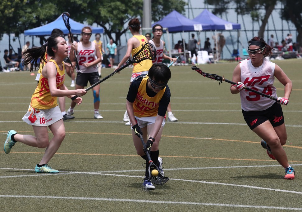 Li Liu (left) and Carrie Lam (right) chase the ball. Photo: Jonathan Wong