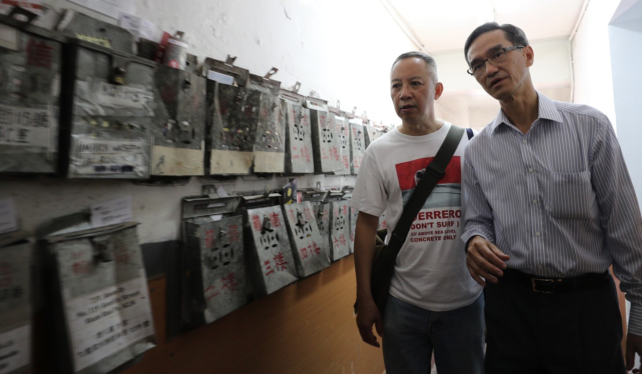 The chairman of the task force on land supply, Stanley Wong (right), and Ho Hei-wah, director of the Society for Community Organisation, visit residents of subdivided flats in Sham Shui Po. Photo: Winson Wong